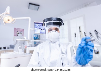 Dentist Pov In Covid Suit Examining Mouth Hygine Using Dental Tools. Stomatolog Wearing Safety Gear Against Coronavirus During Heatlhcare Check Of Patient.