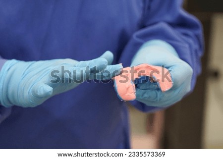 Dentist preparing to make jaw moulds using dental molding materials