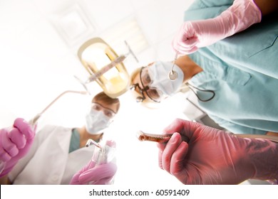 A Dentist Ready To Drill On Teeth, Focus On The Drill