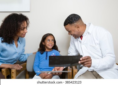 Dentist showing patient x ray