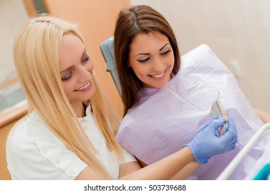 Dentist Showing Porcelain Crowns To The Female Patient. 