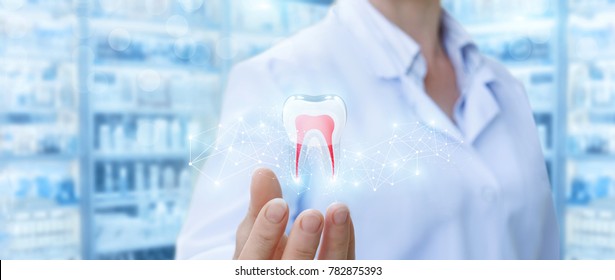 Dentist Showing Tooth Model On Blurred Background.