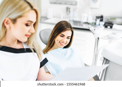 Dentist Showing X-ray For The Patient And Explaining Plan Of Treatment