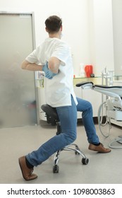 Dentist Stretching His Legs And Arms At Work