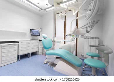 Dentist Surgery Room With Dentist Chair And Tools, No People Are Visible.