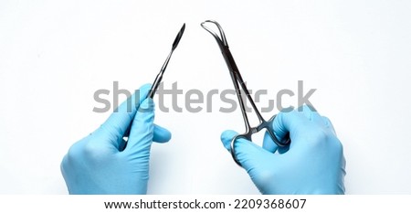 Dentist with surgical tools on white background