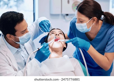 Dentist team, patient and cleaning mouth for hygiene with healthcare and consultation, surgery and tooth extraction. People, teeth inspection and orthodontist with medical procedure for veneers - Powered by Shutterstock