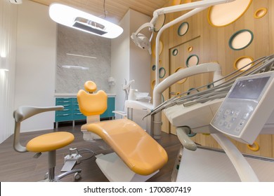 Dentist Tools And Professional Children Dentistry Chair Waiting To Be Used By Orthodontist, Modern Interior, No People