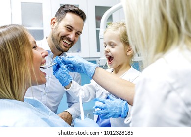 Dentist Treating Cute Blonde Child In His Surgery. 