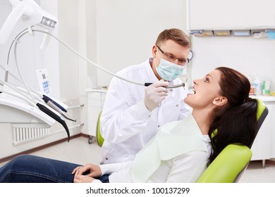 The dentist treats teeth of the patient in the clinic - Powered by Shutterstock