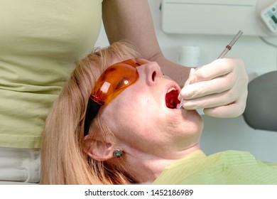 Dentist Use A Anesthetic Oral Gel To Numb The Area Around Tooth Before Injection Of Anesthetic Solution..