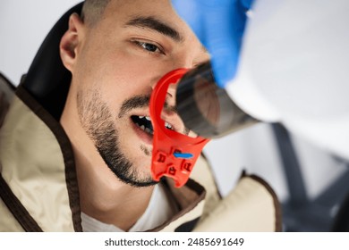 Dentist uses x-ray hardware to analyze patients teeth condition. X-ray teeth scanning process - Powered by Shutterstock