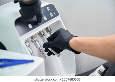 Dentist using chuck cleaning to completely remove dirt and cutting powder