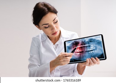 Dentist Using Digital Tablet Technology For Teeth Xray