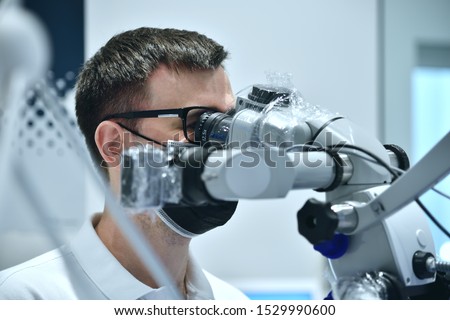 Dentist Using Microscope With Camera In Dental Clinic. Medical Inovation Concept. Close Up
