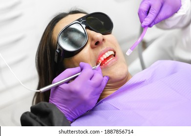 Dentist Using A Modern Diode Dental Laser. High Quality Photo