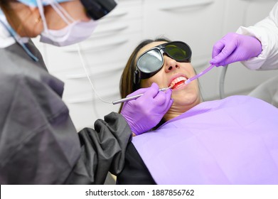 Dentist Using A Modern Diode Dental Laser. High Quality Photo