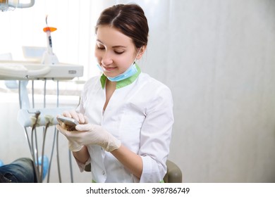 Dentist Woman Calling Phone In The Dental Office