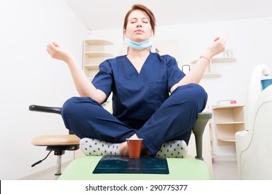 Dentist woman meditating with yoga and lotus position. Coffee break and relaxing lifestyle as a doctor