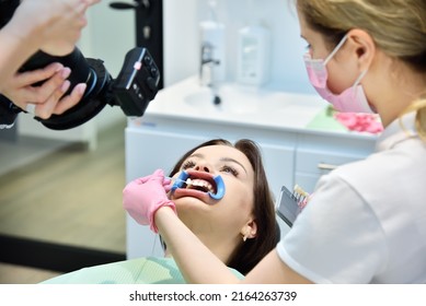 Dentist woman photographing teeth before teeth whitening procedure. Dental And Teeth Whitening Concept. Close up