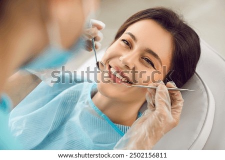 Image, Stock Photo Dentist and patient at modern medical center. Doctor treats a young woman teeth in hospital. Practitioner examines the patient before orthodontists or prosthetics treatment.