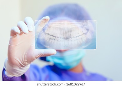 Dentistry And Healthcare Concept At Dental Clinic. Dentist Check-up Teeth X-ray Film With Innovation Technology.