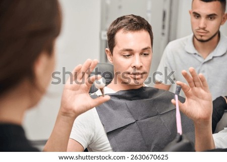 Dentists explaining process of dental implants installation to client