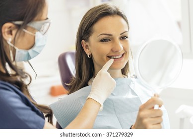 Dentists with a patient during a dental intervention. Dentist  Concept - Powered by Shutterstock