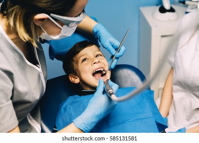 Dentists with a patient during a dental intervention to boy. Dentist  Concept