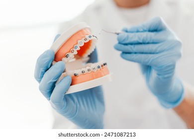 Dentist's work in dental office, showing jaw with braces. Orthodontic treatment, dental care concept