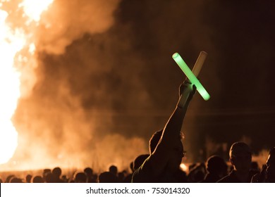 Denton, Texas/United States - November 10, 2017: University Of North Texas Students And Alumni With Green And White Glow Sticks Watching The Bonfire For Homecoming Week