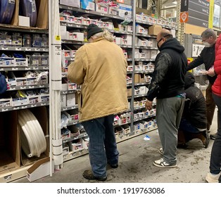 Denton, TX USA - Feb 18, 2021: DIY Contractors shop dwindling stock of plumbing repair supplies at local home improvement store in an effort to fix frozen and busted pipes after Texas winter storm