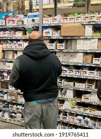 Denton, TX USA - Feb 18, 2021: DIY man searches dwindling stock for plumbing repair supplies to fix frozen pipes after record-breaking Texas winter snow and ice storm