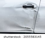 Dents on the car door caused by the accident. scratched car body.