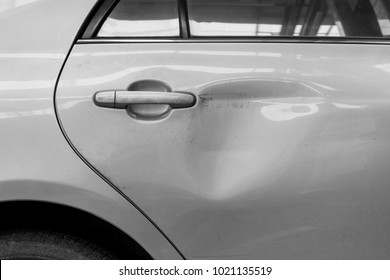 The dents on the car door caused by the accident