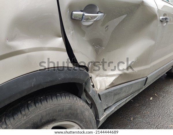 dents on the car\
door caused by the\
accident