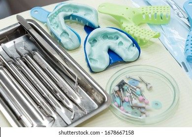 Denture And Implant Production: Dental Impression From Teeth With Silicone Material. Dental Spatula With Print For Dental Implant