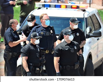 Denver, CO, USA, April 19, 2020.  Denver Police wearing face masks monitored the Stay at Home peaceful protest at the Denver, Capital. They mostly directed traffic and kept everyone safe. 