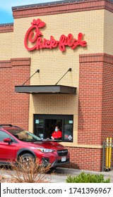 Denver, CO, USA. May 12, 2020. Fast Food Worker At Chick-Fil-A Restaurant In Denver Serving Food To A Drive Thru Customer While Wearing Her Face Mask. 