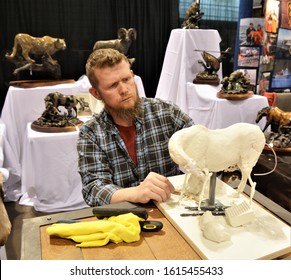 Denver, CO, USA. Oct 11, 2020. Bronze figure sculptor Arron Barkley giving a demonstration on how he creates his beautiful bronze animal sculptures at a free local outdoor sports show in Denver. 