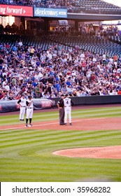 DENVER, COLORADO - AUGUST 11: Manager Of The Colorado Rockies Confers With The Third Base Umpire During The Rockies, Cubs Game On August 11, 2009 In Denver Colorado.