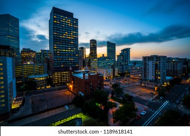 Denver , Colorado Downtown City Lights Illuminate As The Sun Goes Down Behind The Rocky Mountains In The Mile High City Night Life And Night Lights Turn On And Glow