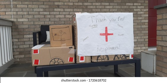 DENVER, COLORADO - MAY 2, 2020: Truck Made Of Cardboard Boxes Set On A Porch Has A Sign 