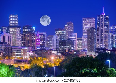Denver Colorado at Night. Denver Downtown Skyline and the Full Moon on Clear Sky. 