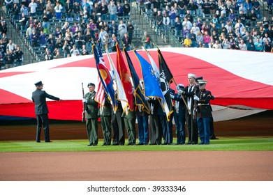 DENVER, COLORADO - OCTOBER 12: Honor Guards Hold The Flags At Pre-game Festivities Before Game 4 Of The  National League Division Series On October 12, 2009 In Denver Colorado.