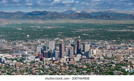 Denver Colorado as seen from above with mountains and clouds