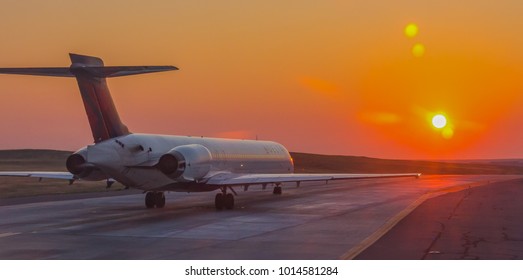 Denver, Colorado, September 2, 2017:  Delta passenger airline early morning flight going into the sunrise, Denver International Airport