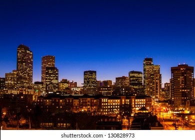 Denver Colorado skyline at dusk during the blue hour with lighted buildings and streets