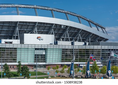 Denver, Colorado / United States Of America - September 7 2019 : Mile High Stadium, Empower Field, Home Of The Denver Broncos NFL Team.  Logo Above Entrance On A Sunny Day, Flags In Front.