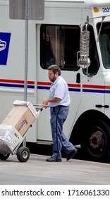 Denver Colorado USA Aug 4 2014 ; A Postal Employee Delivers Mail In A Busy City